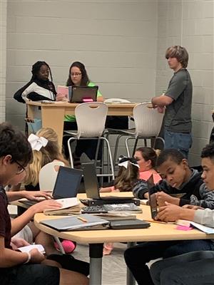 teacher helping student in library